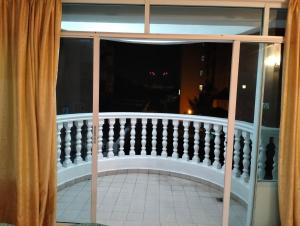 a view of a balcony from a window at Pantai Puteri Kondominium in Kampong Bukit Darat