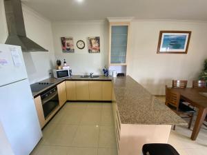a kitchen with a counter top and a refrigerator at Unit 29 Seafront Estate in Jurien Bay