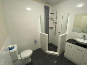 a bathroom with a toilet and a shower and a sink at Unit 29 Seafront Estate in Jurien Bay +8 photos