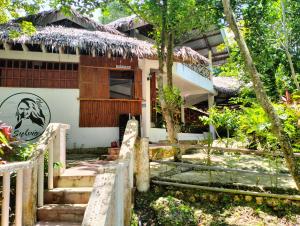 a house in the jungle with stairs leading up to it at The Sylvia in San Juan