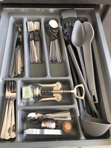 a tray filled with utensils and utensils at studio m - Stylish Central City Business Apartment for 5 guests in Düsseldorf