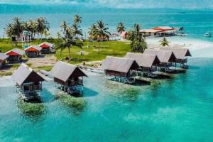 a group of huts in the water on a beach at Private Cabin Over the Water PLUS Meals - San Blas Islands - private bathroom in Panama City