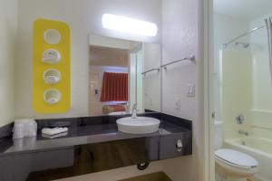 a bathroom with a sink and a toilet and a mirror at Motel 6-Las Vegas, NV - I-15 Stadium in Las Vegas