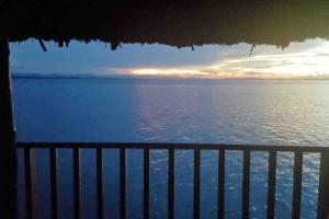 a view of the ocean from a balcony at San Blas Islands - Private Cabin Over-the-Ocean + Meals + Island Tours in Mandinga