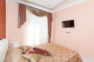 a bedroom with a bed with a television on the wall at Impero Vaticano San Pietro in Rome