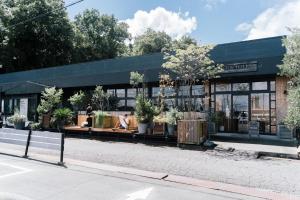 FOLK FOLK Hostel, Cafe & Bar في إيسي: مبنى أمامه نباتات الفخار