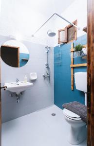 a blue and white bathroom with a toilet and a sink at OVGORA - Ismini Sea View Room in Kamilari Village in Kamilari