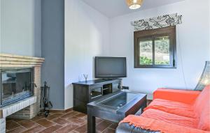 a living room with a couch and a tv at Lovely Home In El Jaral in El Gastor