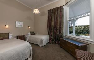 a hotel room with two beds and a window at Anglesea House & Garden in Renwick