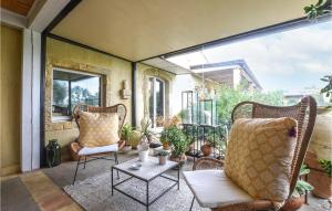 an outdoor patio with chairs and a table at Beautiful Home In Caltagirone in Caltagirone