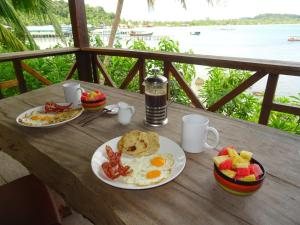 a table with two plates of breakfast food on it at Zest'house in Koh Rong Island