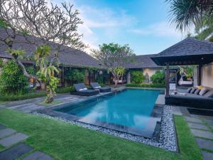 a swimming pool in the backyard of a villa at Peppers Seminyak in Seminyak