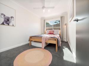 a bedroom with a bed and a window at Boutique by Jervis Bay by Experience Jervis Bay in Vincentia