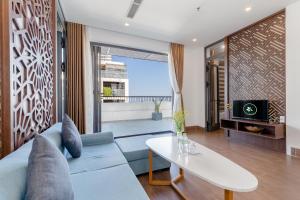a living room with a couch and a table at Smeraldo Hotel & Apartment in Da Nang