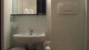 a bathroom with a sink and a toilet at Hotel Locanda Ca' Foscari in Venice