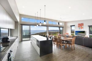 a kitchen and dining room with a table and chairs at Palkana in Wentworth Falls