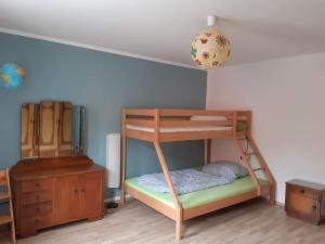 a bunk bed in a room with a dresser at Große Ferienwohnung in Flecken Zechlin in Rheinsberg