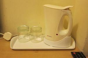 a white blender sitting on a tray with two glasses at Wai fan Guest house in Hong Kong +38 photos