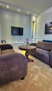 a living room with a couch and a table at Apartman 993 in Pale