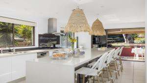 a kitchen with a large island with white counter tops at Shoal Bay Oasis in Shoal Bay