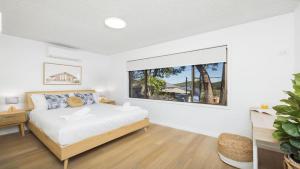 a bedroom with a bed and a large window at Shoal Bay Oasis in Shoal Bay +22 photos