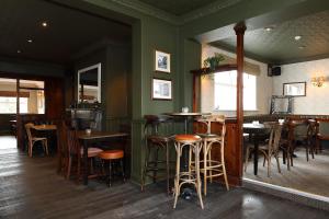 a bar with wooden stools and tables in a restaurant at The Avenue in Durham