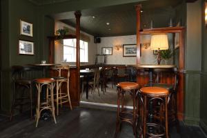 a bar with wooden stools in a restaurant at The Avenue in Durham