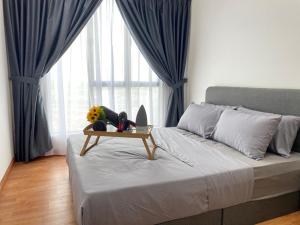 a bedroom with a bed with a table on it at The Platino By Antlerzone in Johor Bahru