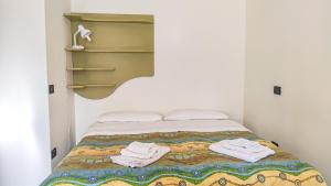 una camera da letto con un letto e asciugamani di La Pineta ad Albenga