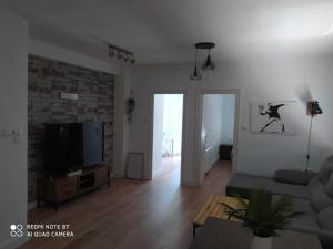 a living room with a couch and a tv at Aparramento Rosa in Murcia