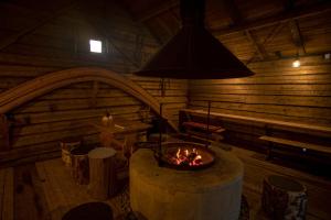 a room with a fireplace in a log cabin at Yurt District in Rovaniemi