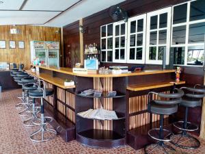 a bar in a restaurant with a row of stools at Homestay Chiangrai in Chiang Rai