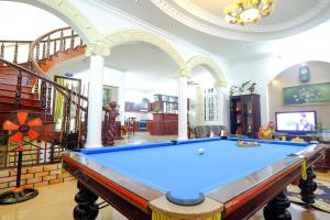 a pool table in a living room with a staircase at Hoàng My Villa F1 in Vung Tau
