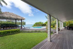 an outdoor deck with a view of the ocean at Muri Beach Villa in Rarotonga