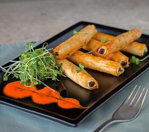 a black plate with carrots on a table with a fork at The Park Visakhapatnam in Visakhapatnam