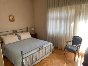 sypialnia z łóżkiem, krzesłem i oknem w obiekcie Il Salottino di San Paolo w Rzymie