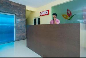 a man talking on a cell phone in an office at HOTEL SLN INN in Bangalore