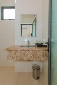 a bathroom with a sink and a mirror at ROSA VILLA & HOTEL Dalat in Da Lat