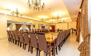 ein Esszimmer mit einem langen Tisch und Stühlen in der Unterkunft Afrique Boutique Hotel O.R. Tambo in Boksburg
