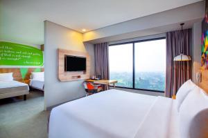 Voodi või voodid majutusasutuse Ibis Styles Bogor Raya toas