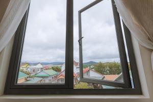 a window with a view of a city at ROSA VILLA & HOTEL Dalat in Da Lat