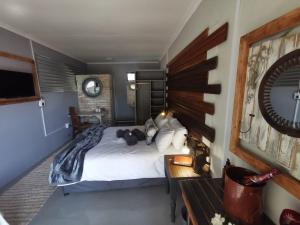 a bedroom with a bed with a teddy bear on it at SomethingElz@Grace in Pretoria