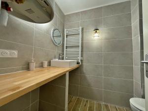 a bathroom with a sink and a mirror at Draguignan, centre ville wifi jolie deco in Draguignan +24 photos