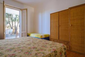 a bedroom with a bed and a dresser and a window at Villa Elena in Porto Cesareo