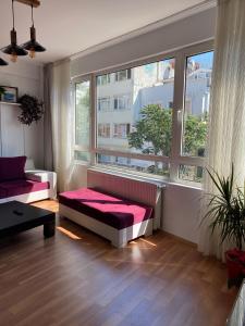 a living room with a couch and a large window at Comfortable house in Üsküdar İstanbul Turkey in Istanbul