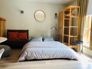 a bedroom with a bed and a mirror on the wall at Estudio reformado Vall d'Incles Grandvalira, 4 pers, max 2 adultos y 2 niños menores 12 años in Canillo