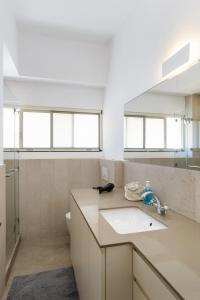 a bathroom with a sink and a toilet at Adorable 2 bedrooms apt w Bomb Shelter next to the beach in Tel Aviv