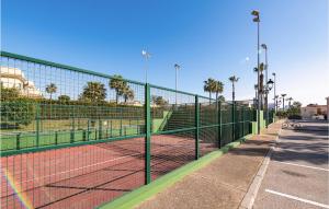 a tennis court with a net on a tennis court at Lovely Apartment In Costa Ballena in Costa Ballena