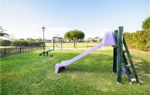 a playground with a purple slide in a park at Lovely Apartment In Costa Ballena in Costa Ballena
