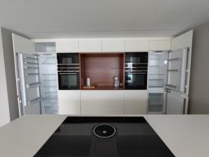 a kitchen with white cabinets and a black floor at VILLA EULALIA in Vinarós